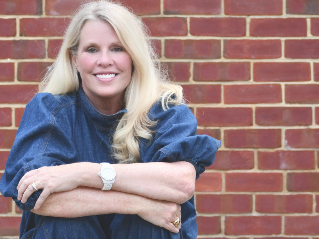 Susan in front of a brick wall